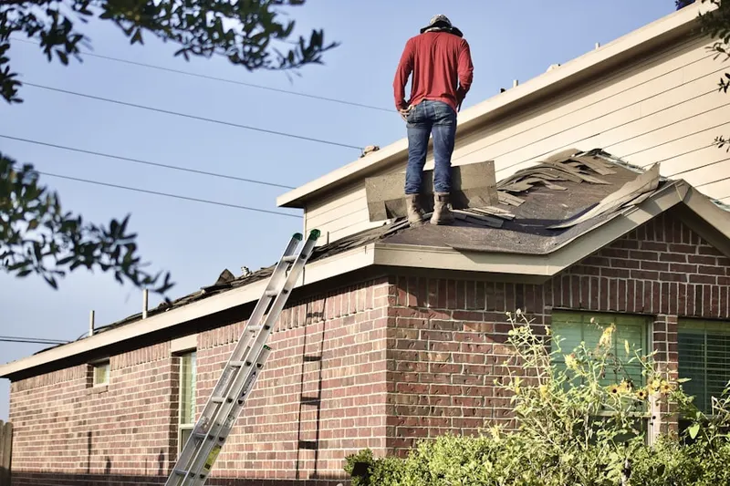 Professional roofer working on a residential roof in Hyannis Port